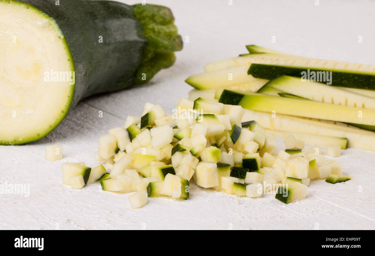 Fresh marrow or courgette cut into batons and diced into small cubes for use in salads and as a vegetable in cooking Stock Photo