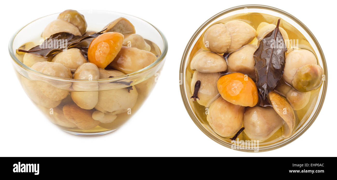 Pickled cepe mushrooms in glass bowl isolated on white background. Side ...