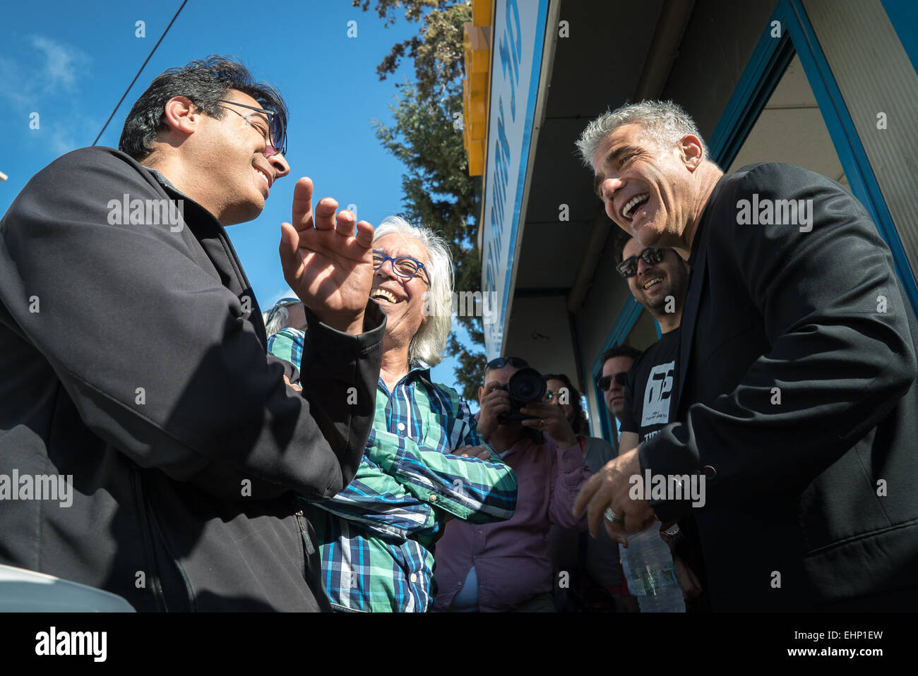 Haifa, Israel. 16th March, 2015. Yair Lapid (1st R, Front), Israel's 'Yesh Atid' Party leader and former Finance Minister, talks to local residents during an elections campaign tour in Haifa, northern Israel, on March 16, 2015, one day before parliamentary elections. Credit:  Xinhua/Alamy Live News Stock Photo
