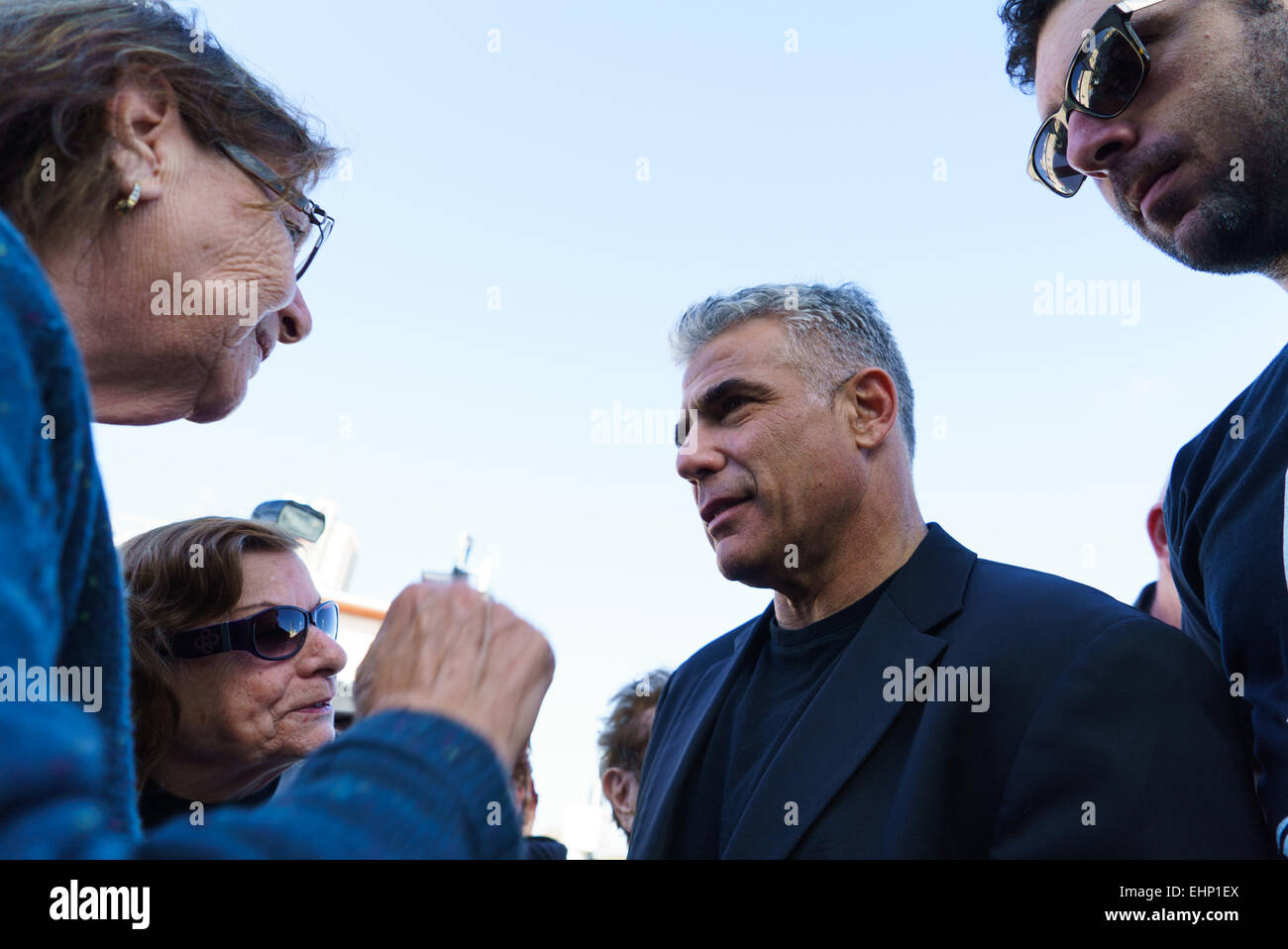 Haifa, Israel. 16th March, 2015. Yair Lapid (2nd R), Israel's 'Yesh Atid' Party leader and former Finance Minister, talks to local residents during an elections campaign tour in Haifa, northern Israel, on March 16, 2015, one day before parliamentary elections. Credit:  Xinhua/Alamy Live News Stock Photo