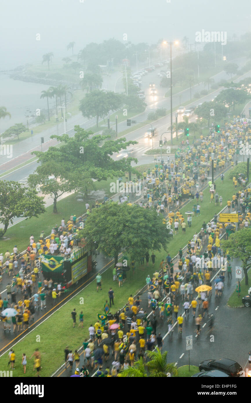 Protesters walk on Beira Mar Norte Avenue under heavy rain in the manifestation for the impeachment of Brazilian president. Stock Photo