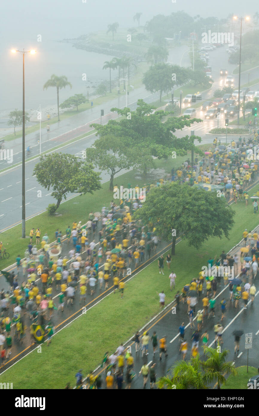 Protesters walk on Beira Mar Norte Avenue under heavy rain in the manifestation for the impeachment of Brazilian president. Stock Photo