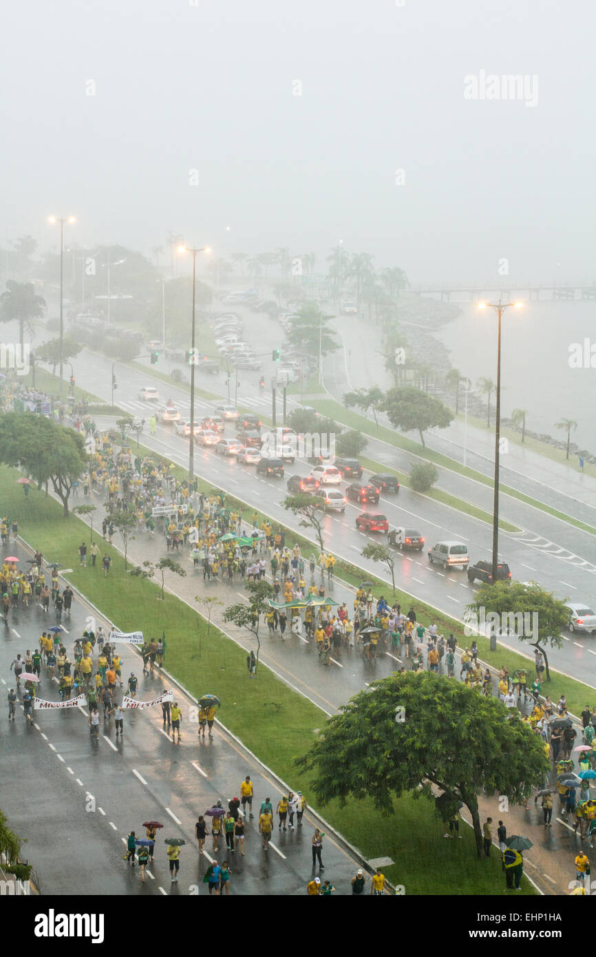 Protesters walk on Beira Mar Norte Avenue under heavy rain in the manifestation for the impeachment of Brazilian president. Stock Photo