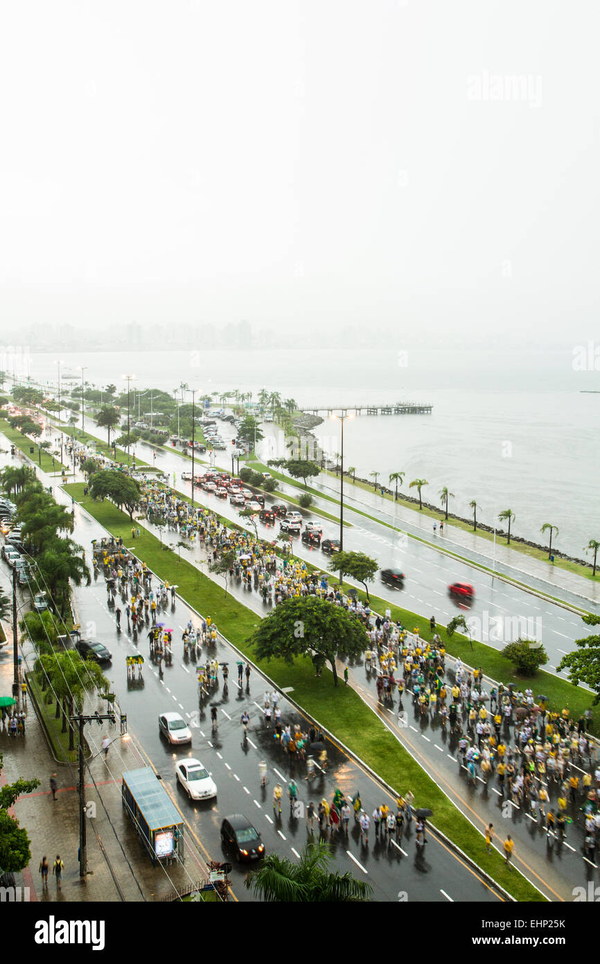 Protesters walk on Beira Mar Norte Avenue under heavy rain in the manifestation for the impeachment of Brazilian president. Stock Photo