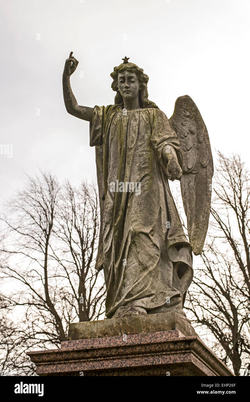 Statue of an angel pointing to the heavens in Morningside Cemetery Edinburgh, Scotland. Stock Photo
