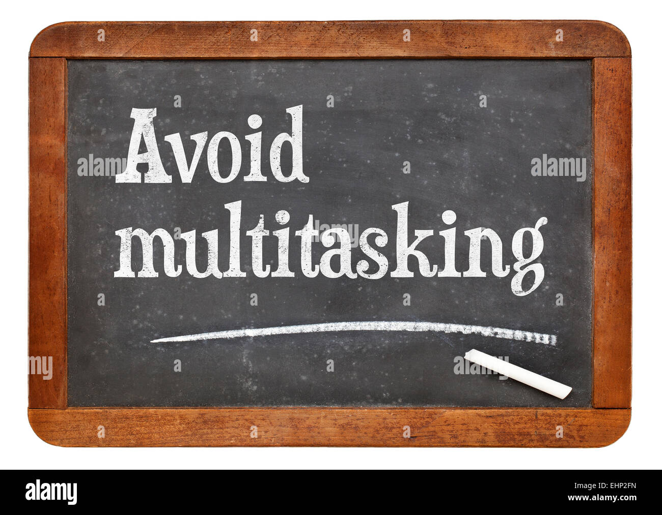 Avoid multitasking advice  on a vintage slate blackboard Stock Photo