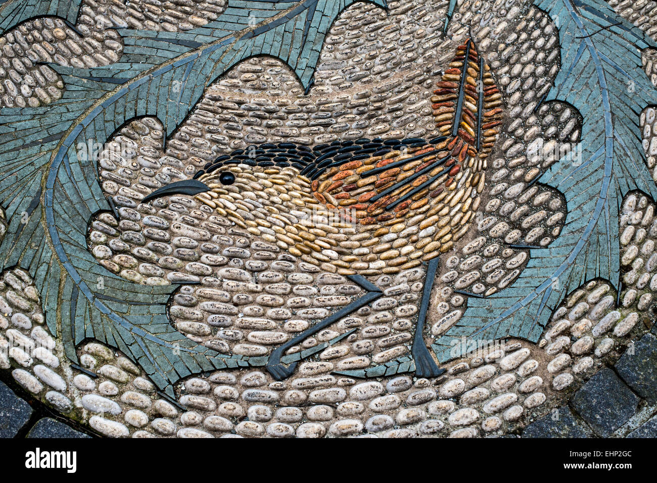 A mosaic of pebbles depicting a bird on a thistle in Queen Street, Edinburgh, Scotland, UK. Stock Photo