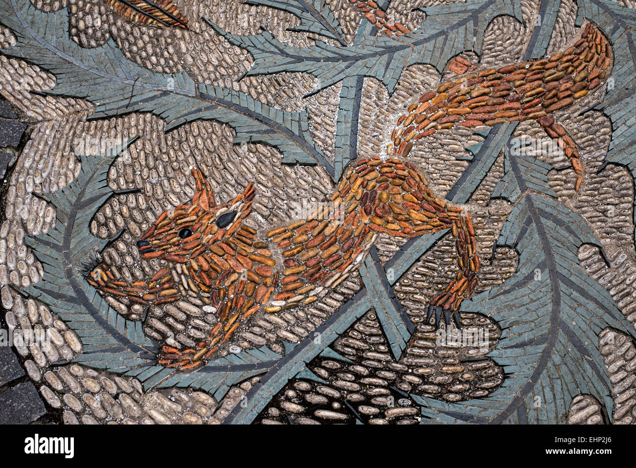 A mosaic of pebbles depicting a squirrel on a thistle in Queen Street, Edinburgh, Scotland, UK. Stock Photo
