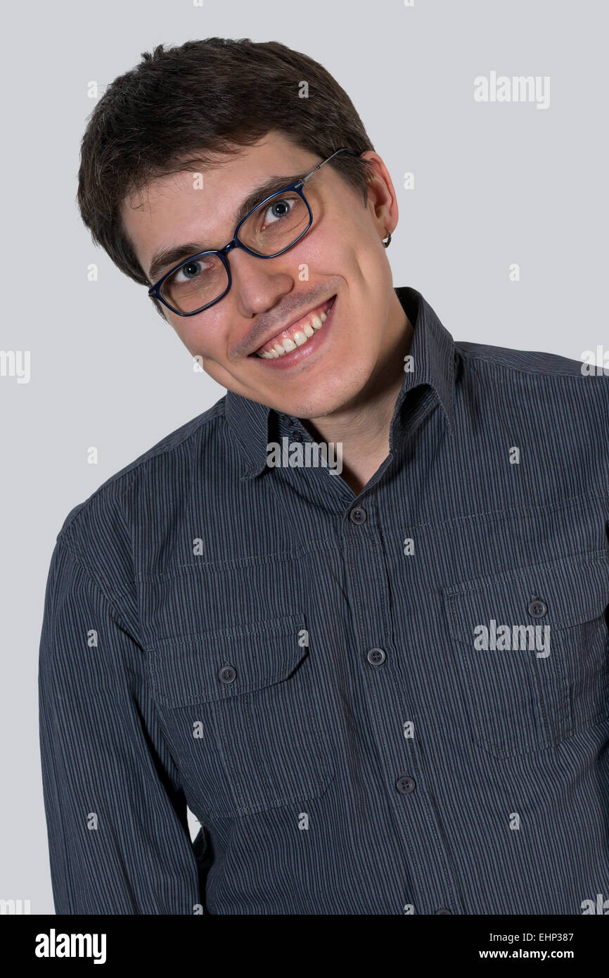 Cheerful young man in the blue shirt and glasses Stock Photo - Alamy