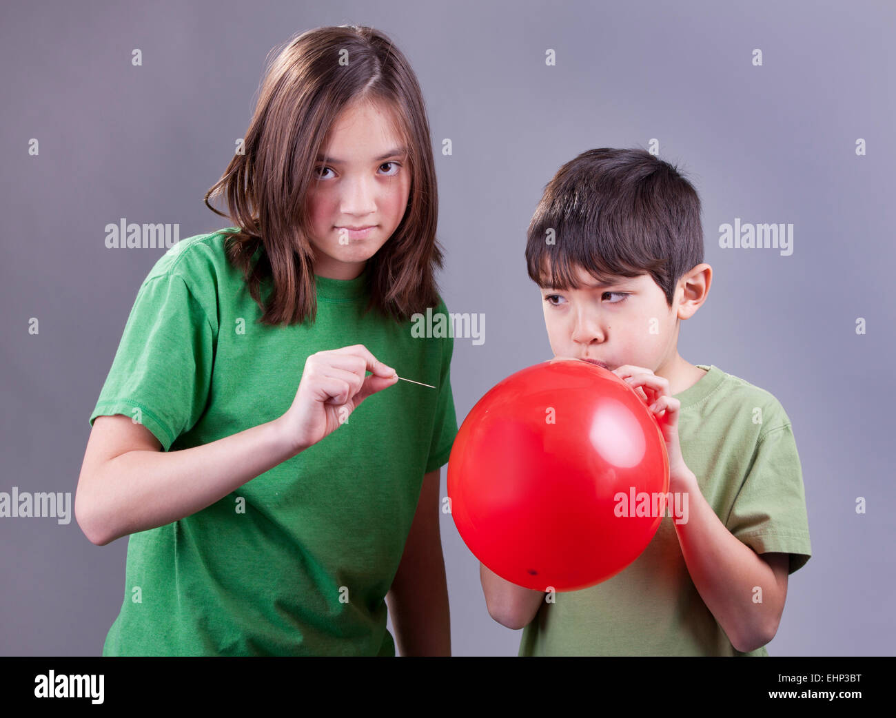 Popping brother's balloon. Stock Photo