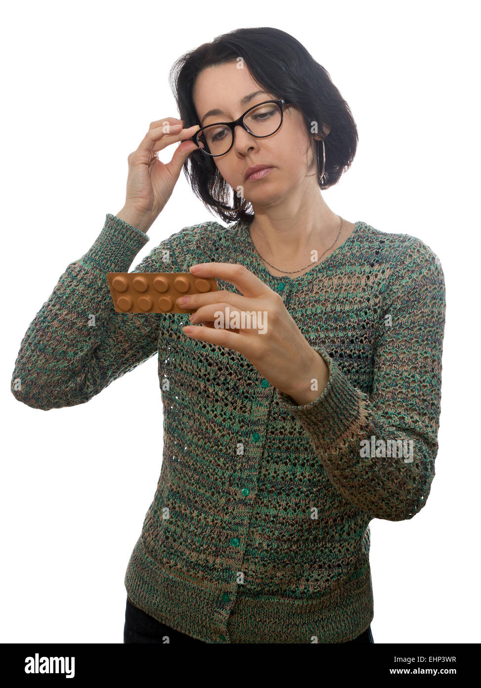 Woman  in  glasses looks at medicament Stock Photo