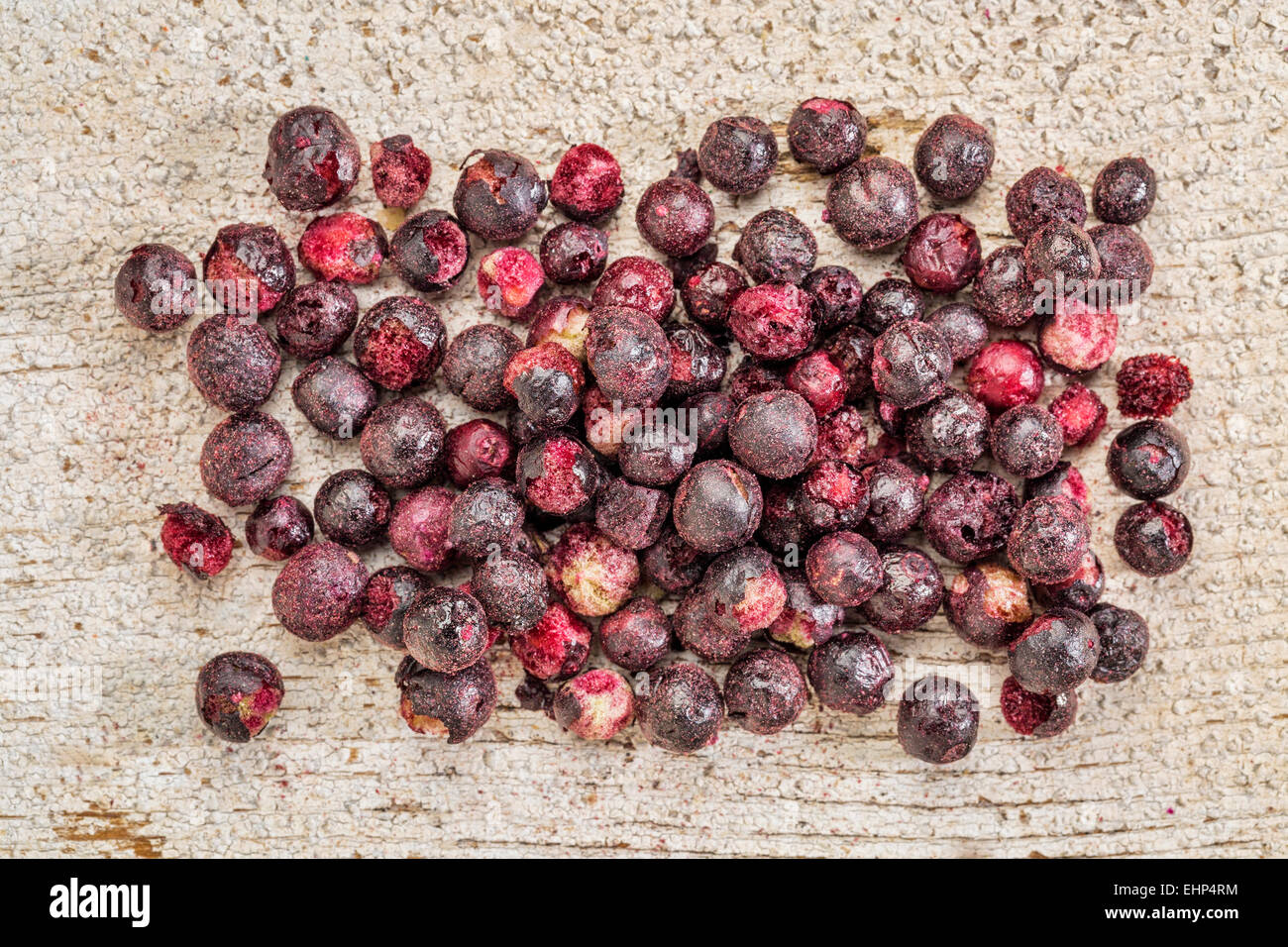 Freeze dried elderberries against rustic barn wood. Elderberries are