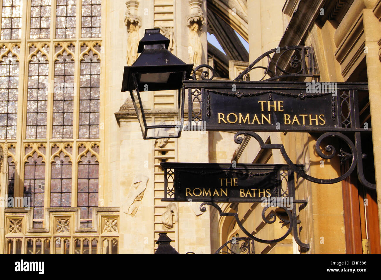 Iron signs for the Roman Baths of Bath England in front of the Abbey Stock Photo