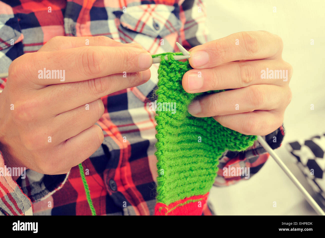 closeup of a young man knitting Stock Photo