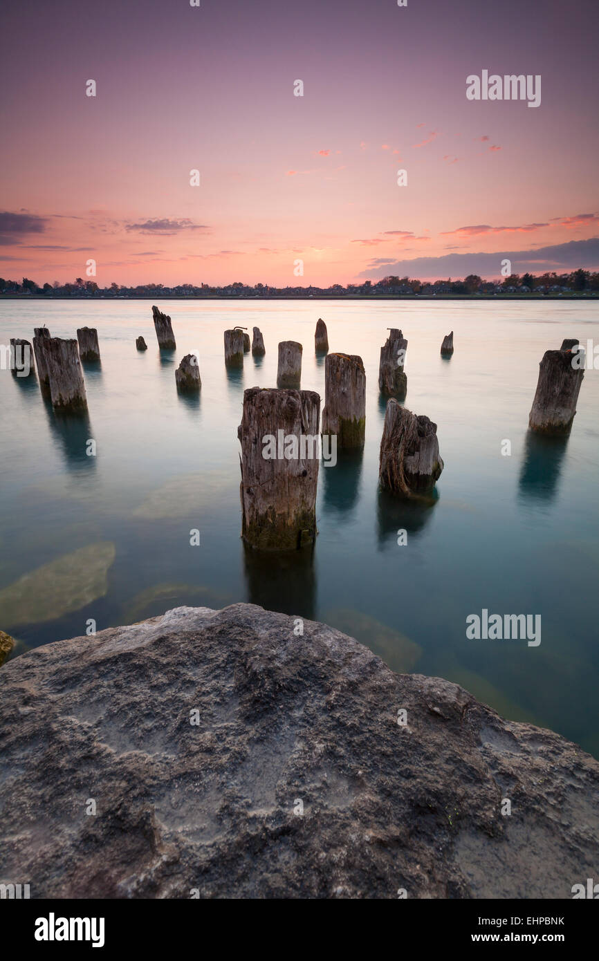 Wooden posts are all that remain of a former pier at Waterfront Park in Point Edward, Ontario Canada. Stock Photo
