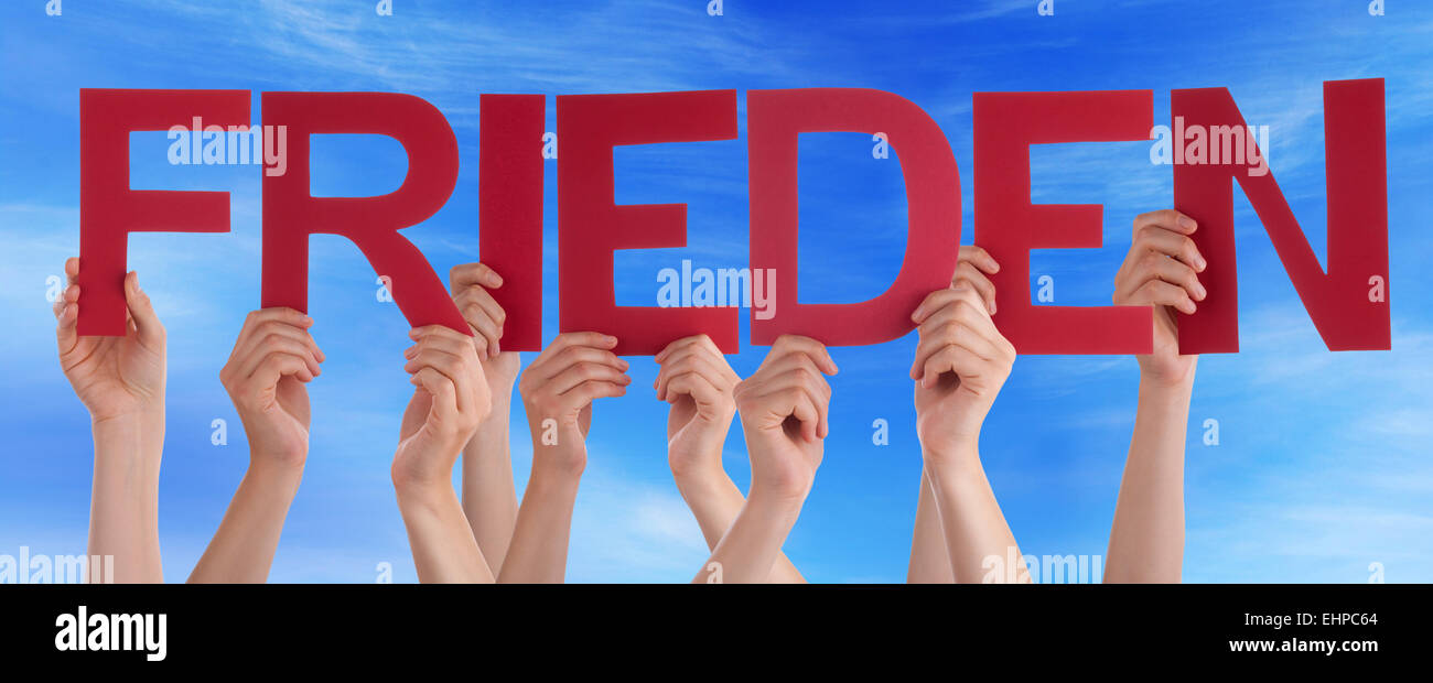Many Caucasian People And Hands Holding Red Straight Letters Or Characters Building The German Word Frieden Which Means Peace On Stock Photo