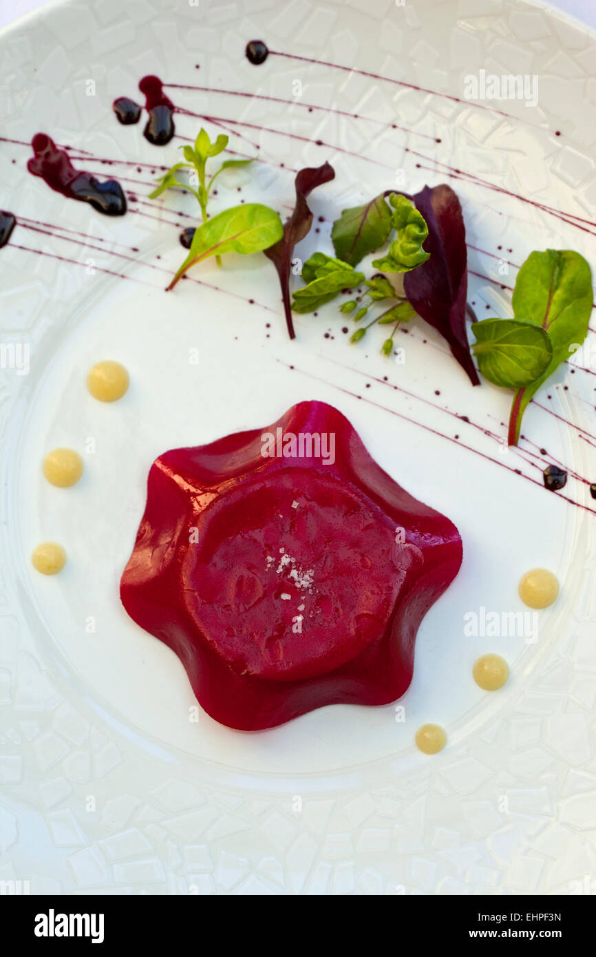 Foie gras and beetroot jelly, green salad and sauce Stock Photo