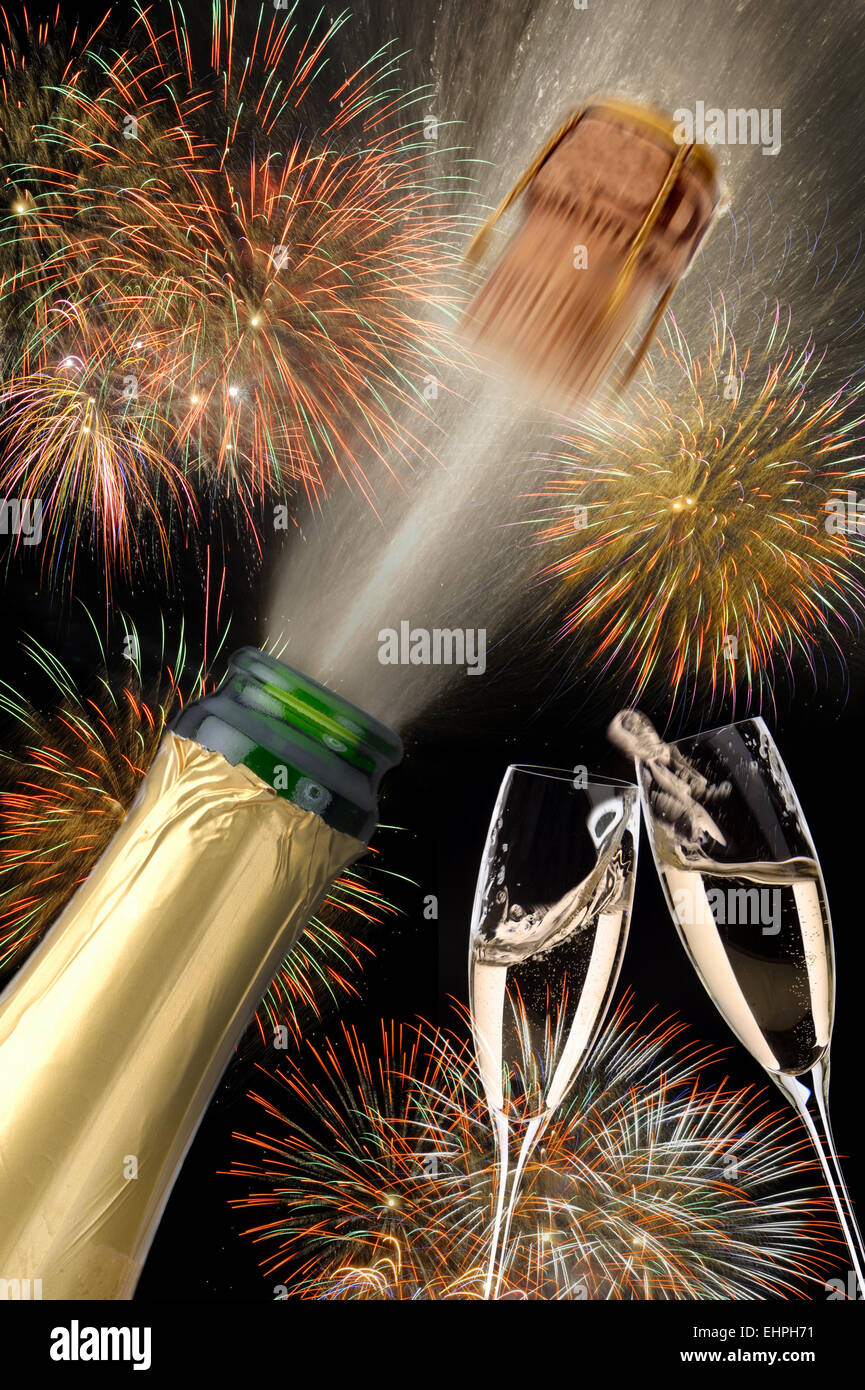 bottle of champagne popping with firework Stock Photo
