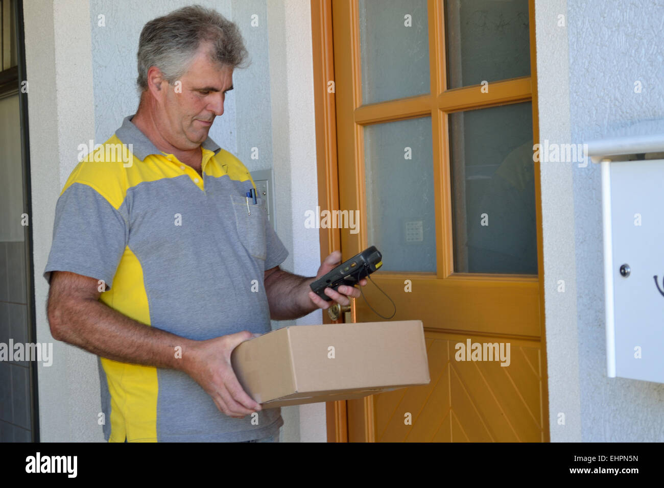 Postman delivers package Stock Photo