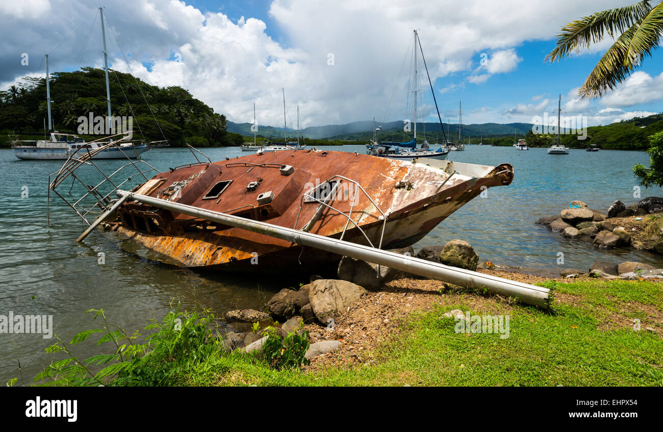 Rusted yacht on the harbor of SavuSavu Fiji Stock Photo
