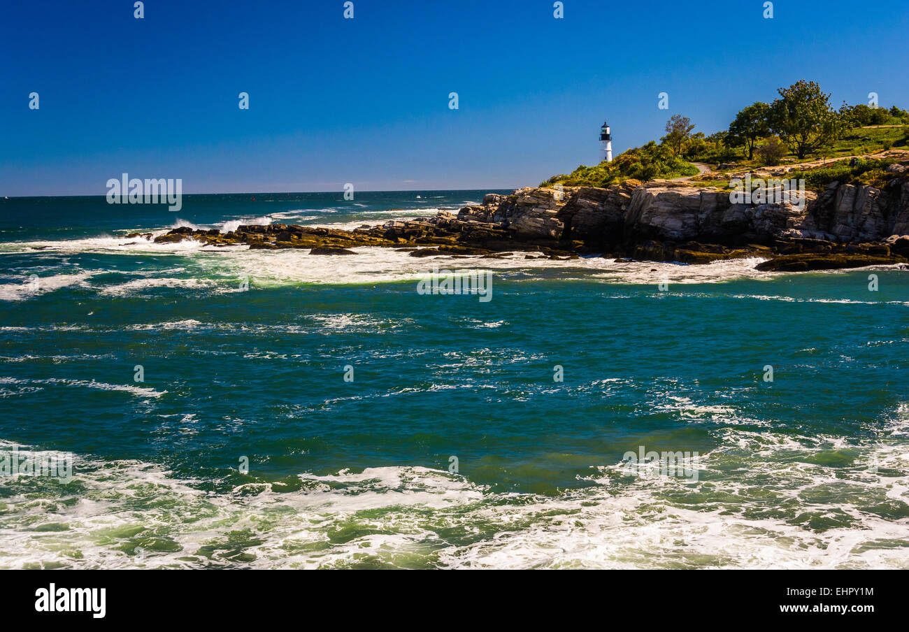 Rocky coast and view of Portland Head Light, at Fort Williams Park, Cape Elizabeth, Maine. Stock Photo