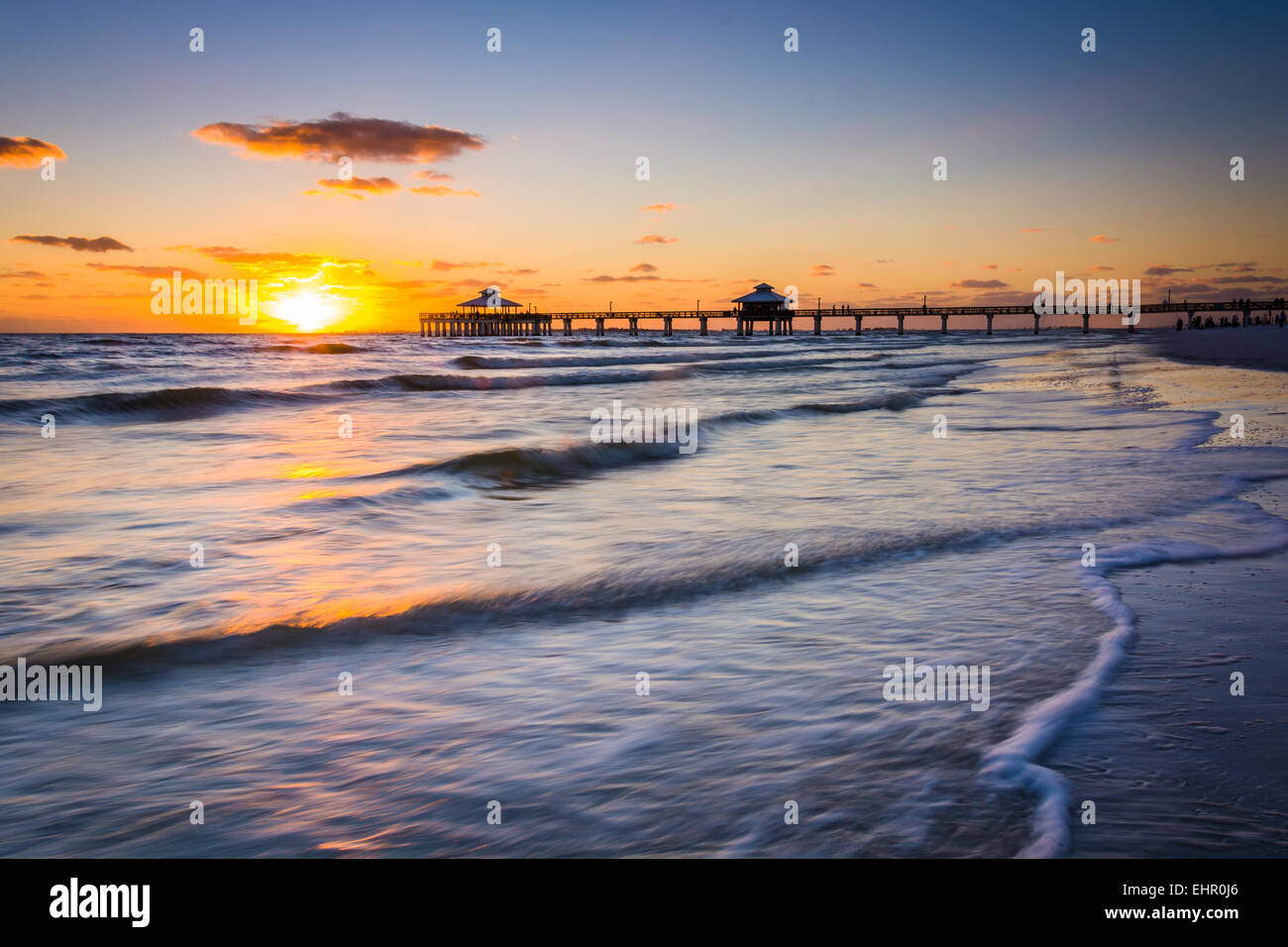 Sunset over the fishing pier and Gulf of Mexico in Fort Myers Beach, Florida. Stock Photo