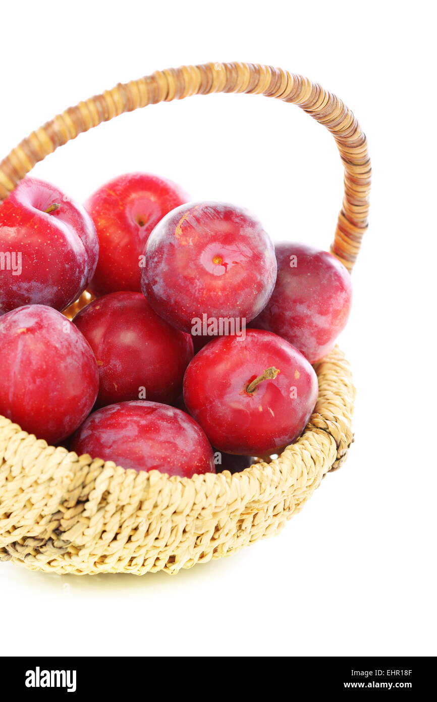 Basket with red plums. Stock Photo