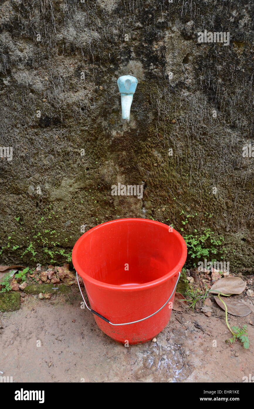 Red Bucket & Water Tap Stock Photo Alamy