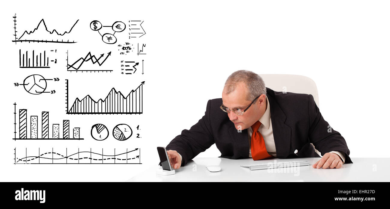 Businessman sitting at desk with diagrams and graphs Stock Photo - Alamy