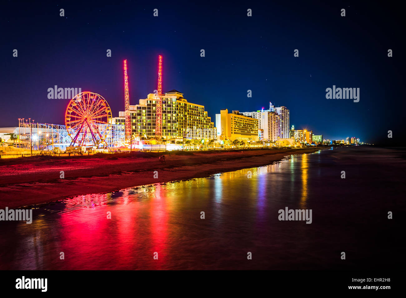 View of hotels and rides along the boardwalk at night from the fishing