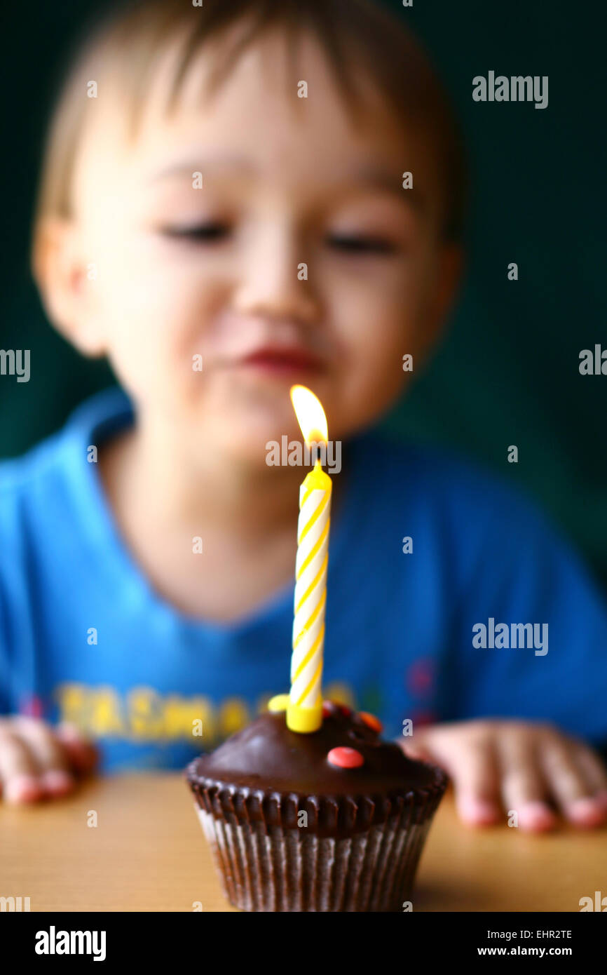 Young boy blowing out birthday candle Stock Photo Alamy