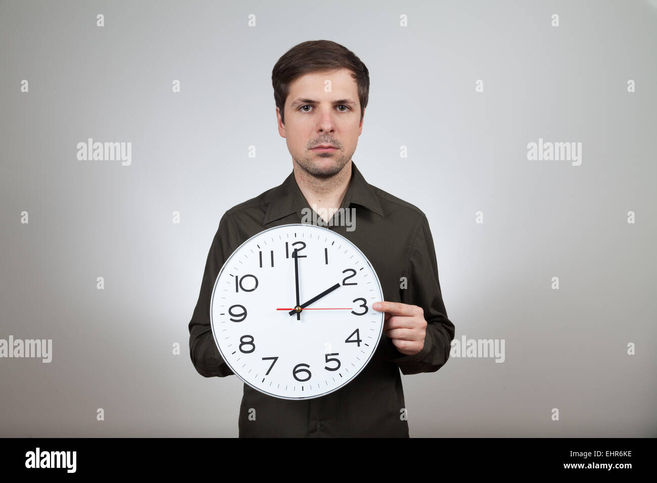 man shows clock change to summertime Stock Photo