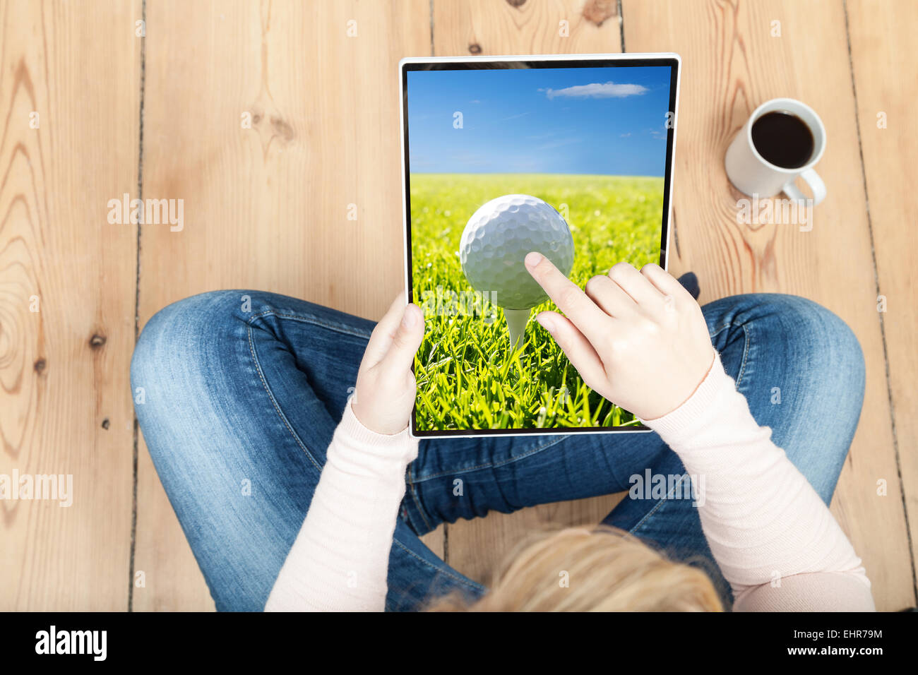woman pointing on golf ball on tablet Stock Photo