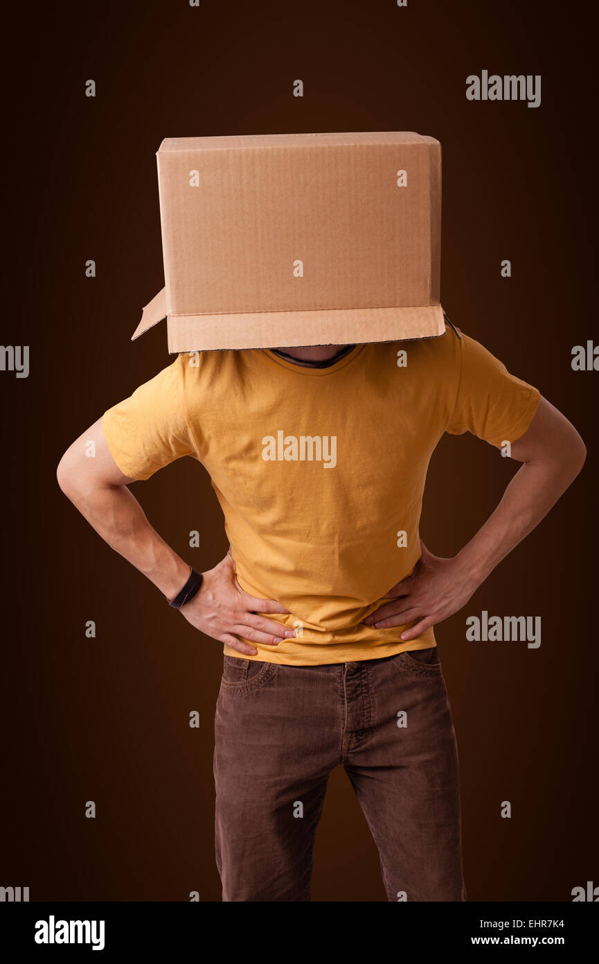 Young man gesturing with a cardboard box on his head Stock Photo - Alamy