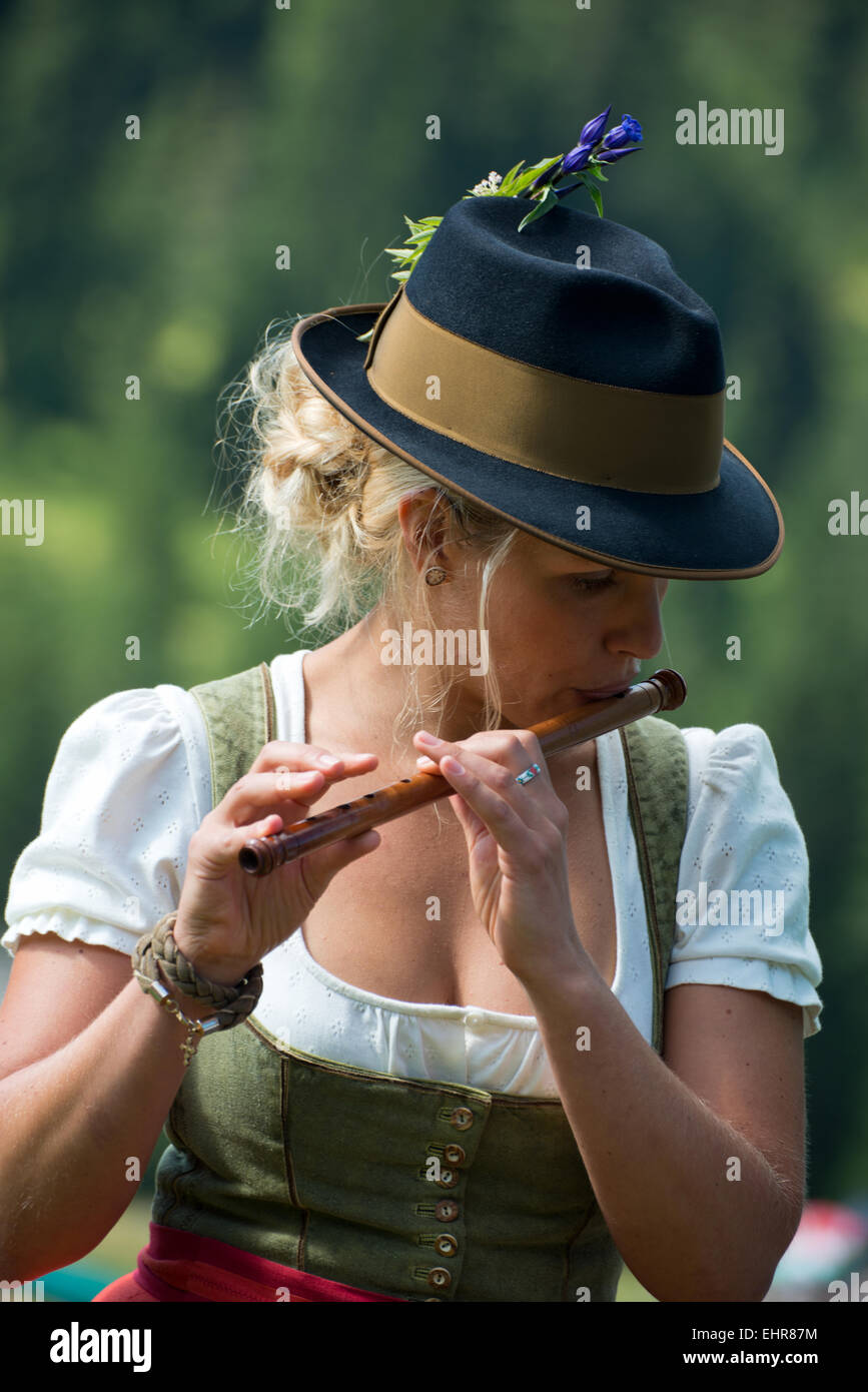 Woman playing cross flute, Seitlpfeifer, Pfeifertag, Dirndl, Salzkammergut, Austria Stock Photo