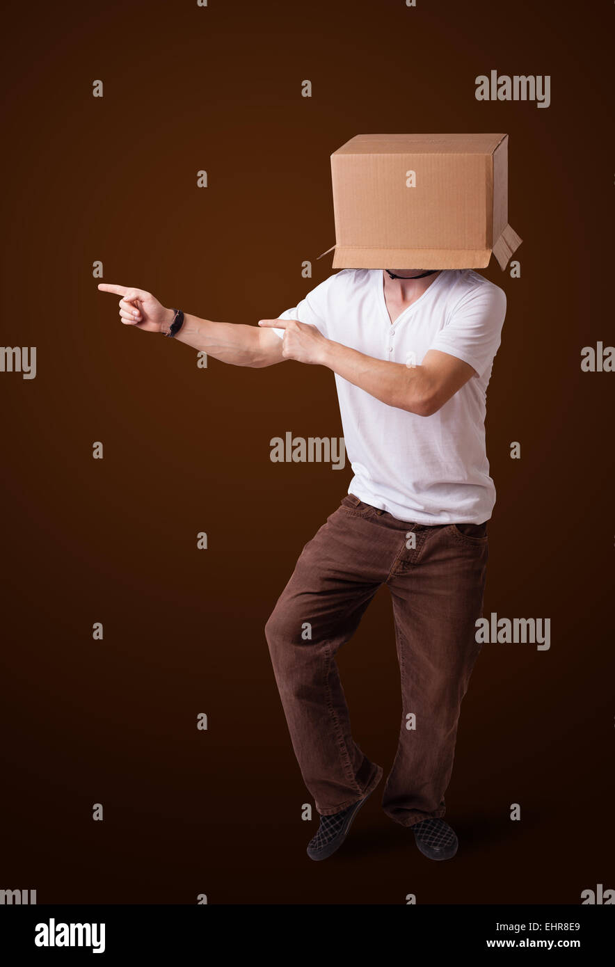 Young man gesturing with a cardboard box on his head Stock Photo - Alamy