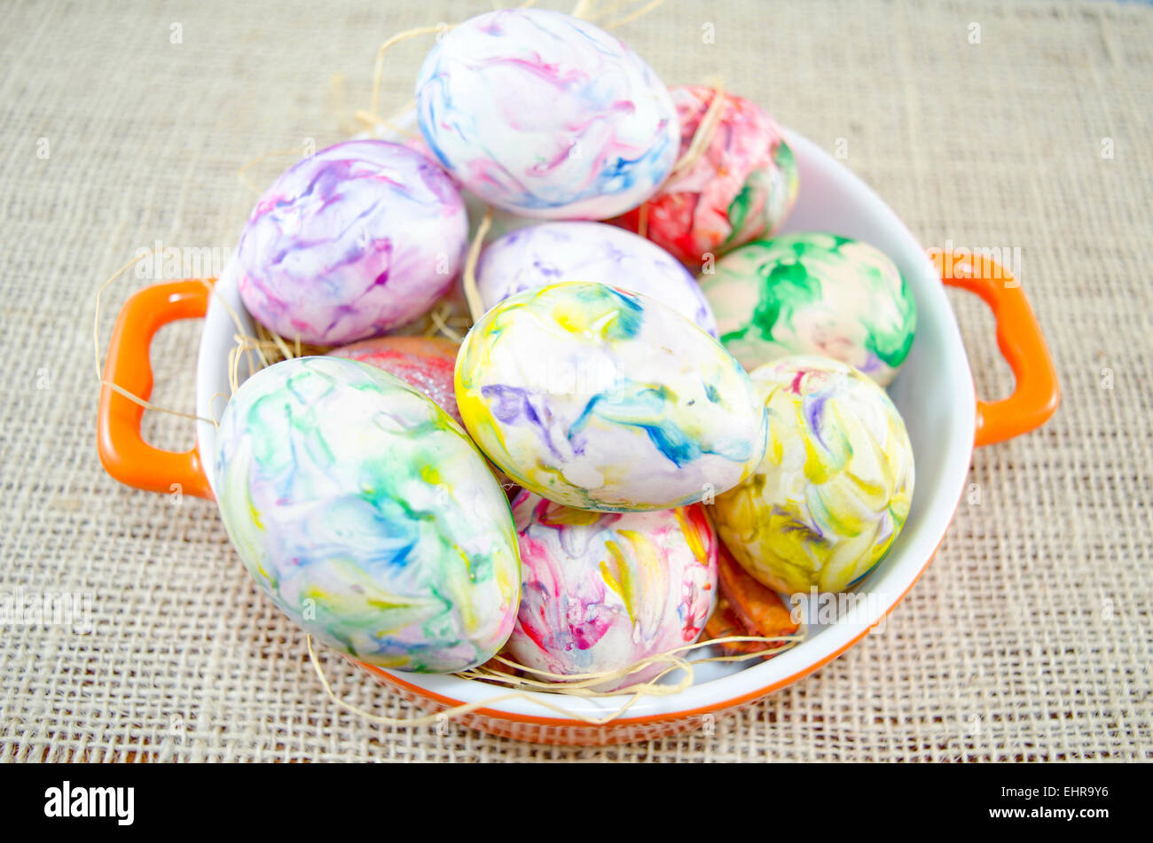Bunch of hand colored Easter eggs close up in a metal pot Stock Photo