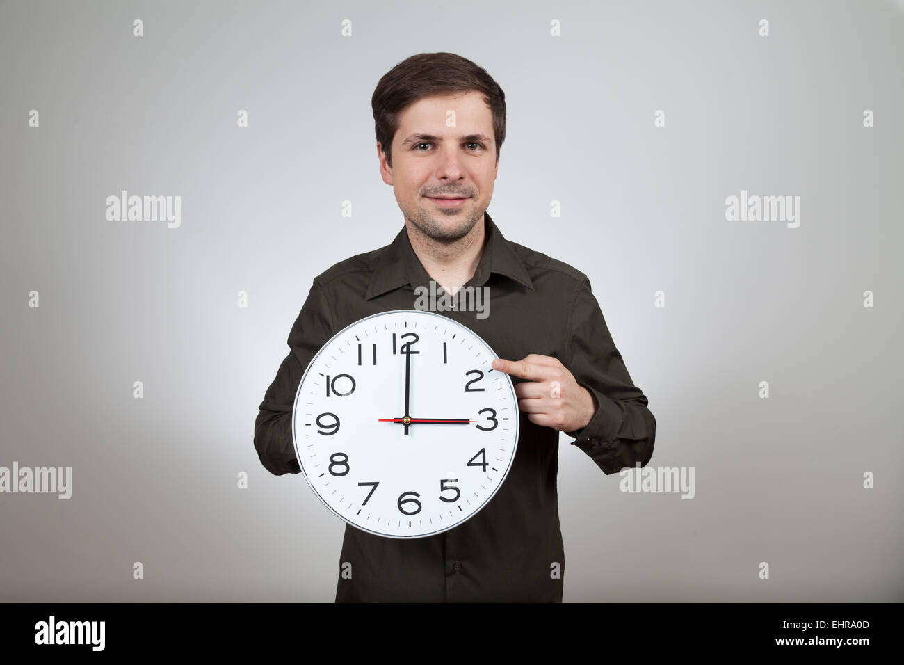 man shows clock change to wintertime Stock Photo