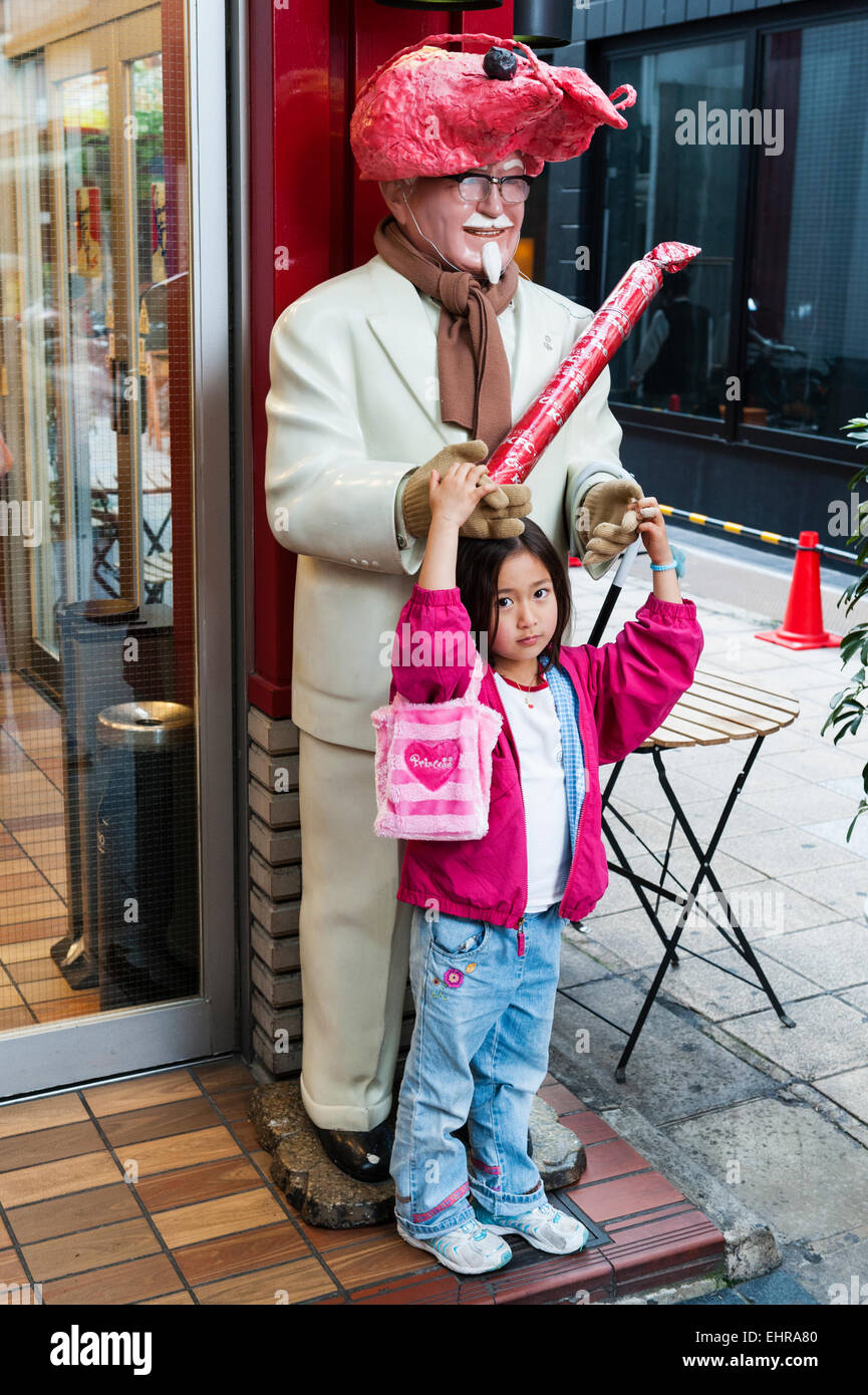 Kyoto, Japan. The Sanjo shopping arcade. Colonel Sanders with a prawn for a hat outside a branch of Kentucky Fried Chicken (KFC) Stock Photo