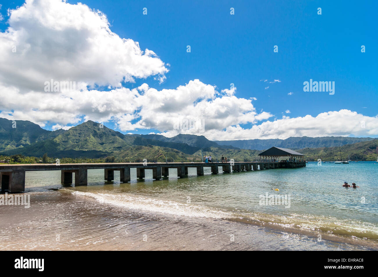 Kauai, HI, USA - August 31, 2013: tourists on Pier and bathing in Hanalei Bay, Kauai Island (Hawaii) Stock Photo