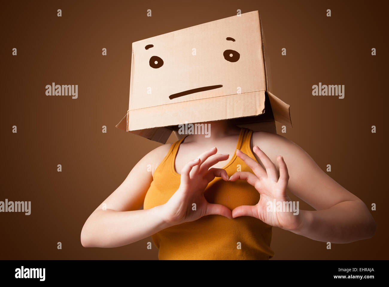 Young girl gesturing with a cardboard box on her head with straight