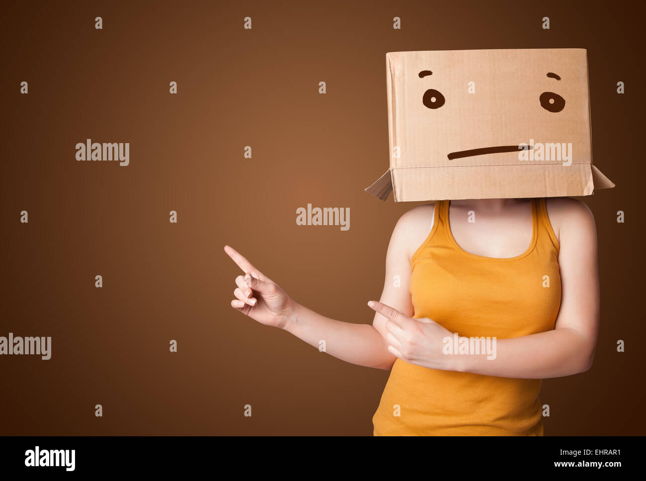 Young girl gesturing with a cardboard box on her head with straight