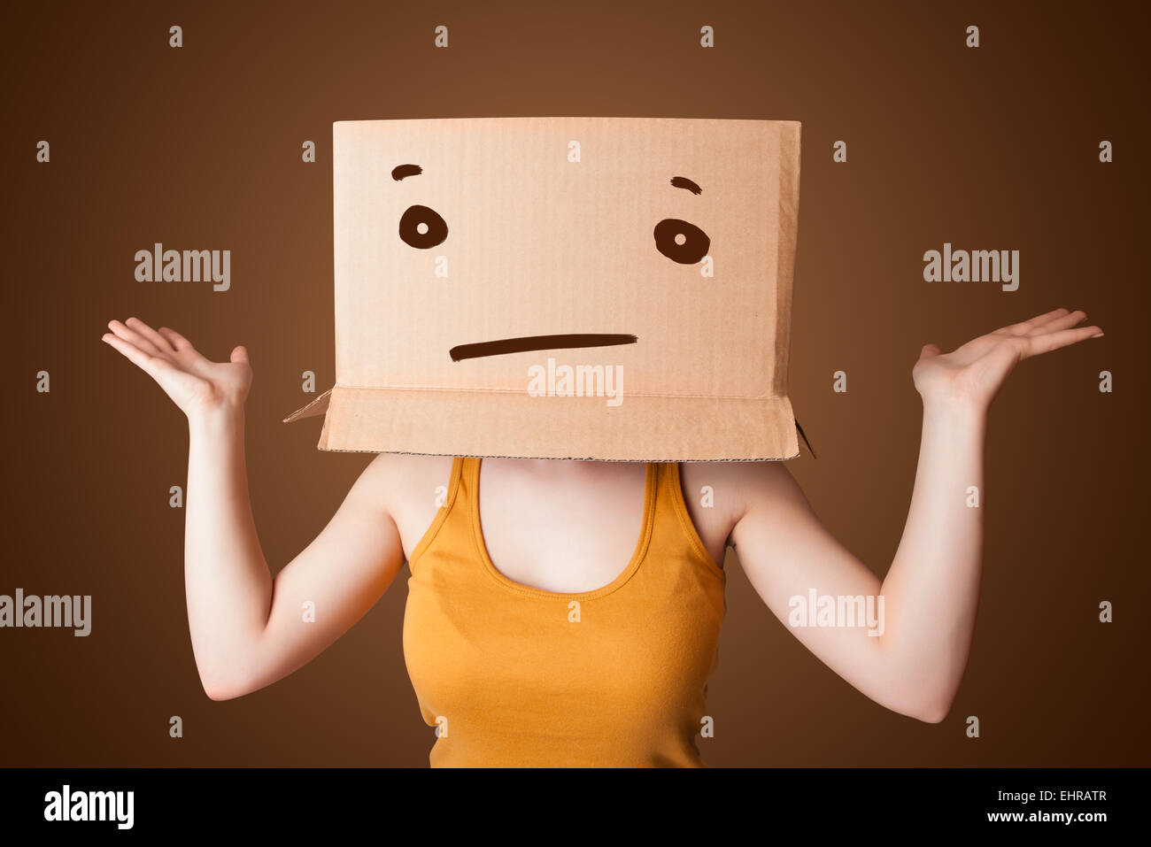 Young girl gesturing with a cardboard box on her head with straight
