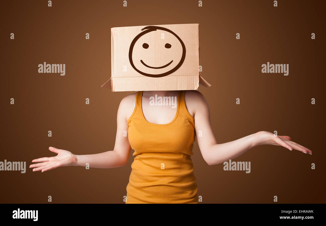 Young girl gesturing with a cardboard box on her head with smiley face