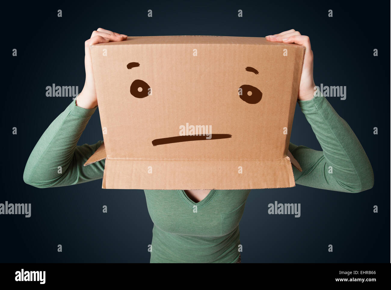 Young girl gesturing with a cardboard box on her head with straight
