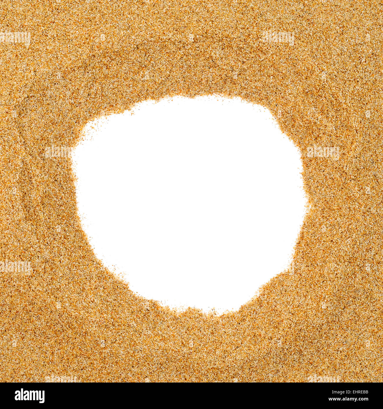 closeup of a pile of sand with a round hole in the middle on a white
