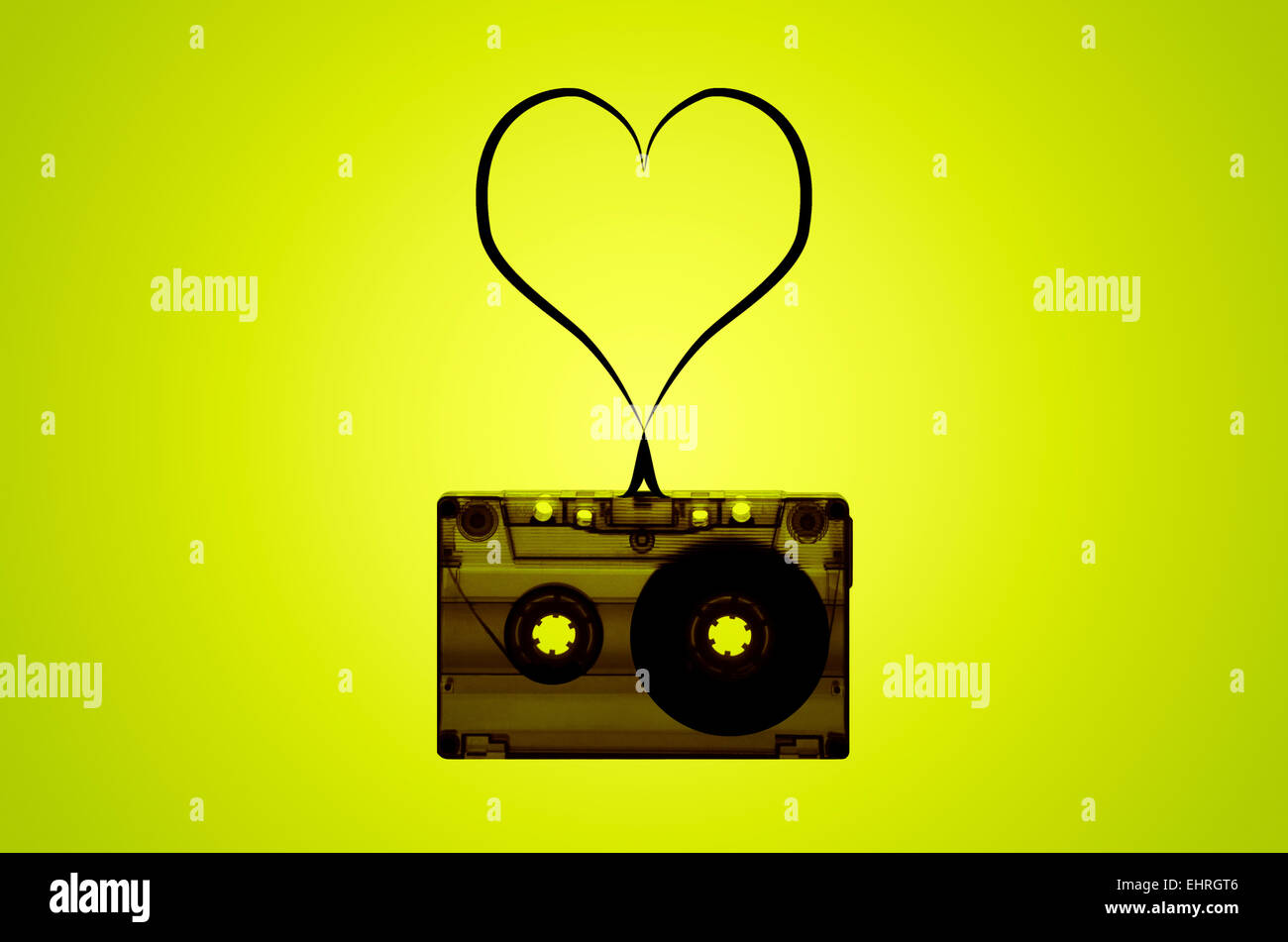 A cassette tape on a lime green backlit background with tape coming