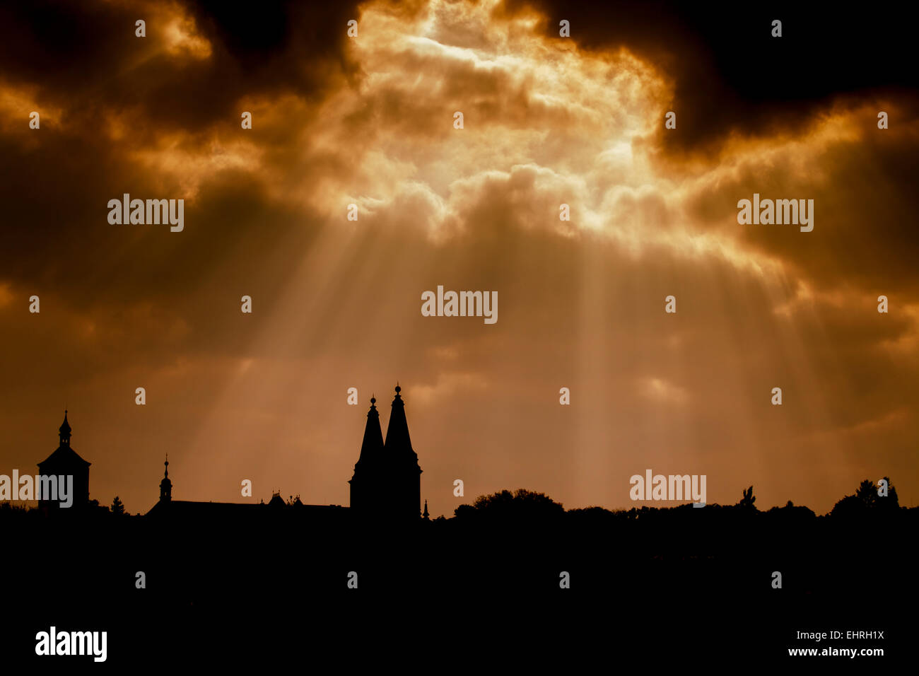 Dramatic dark sky with streaming lights and silhouette of an ancient church in the Czech Republic. Stock Photo