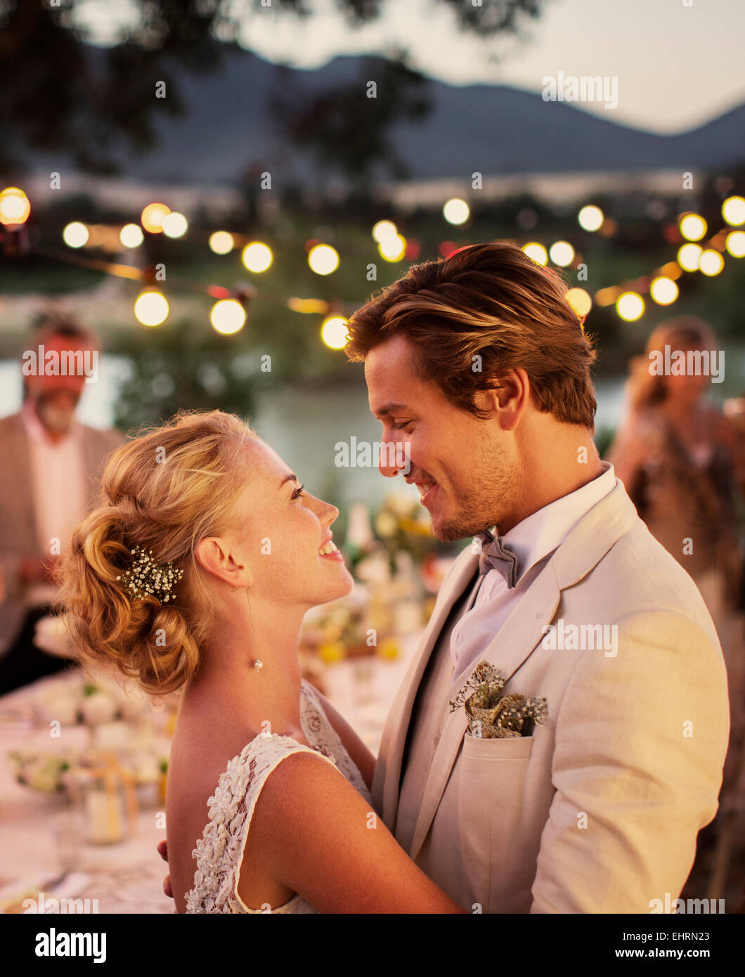 Portrait Of Young Couple Dancing In Garden During Wedding