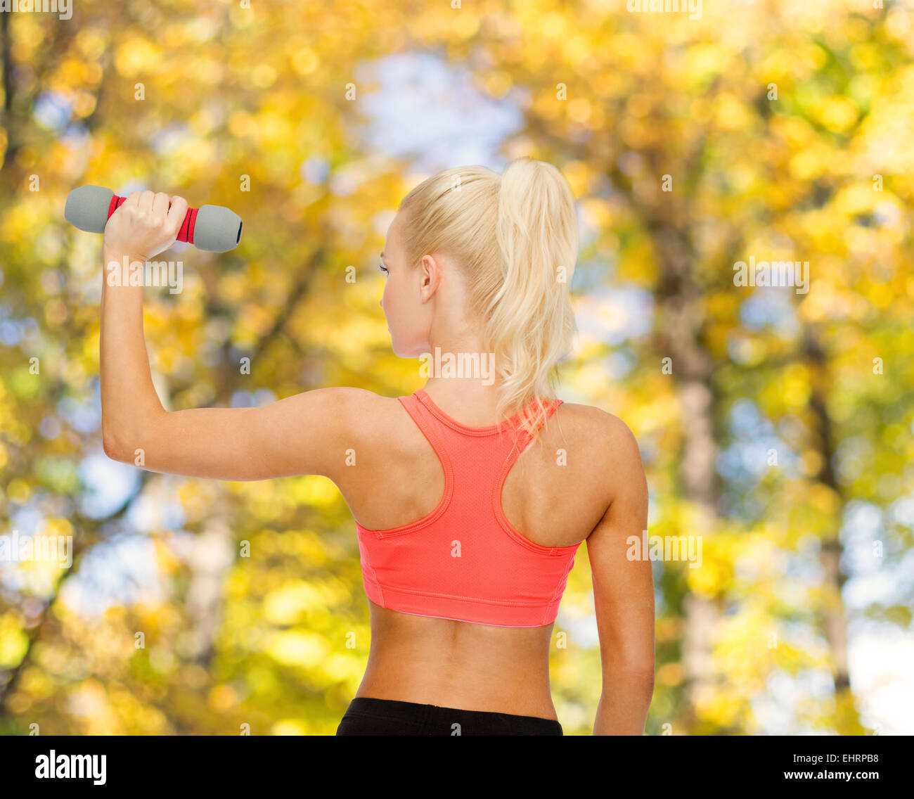 young sporty woman with light dumbbell Stock Photo